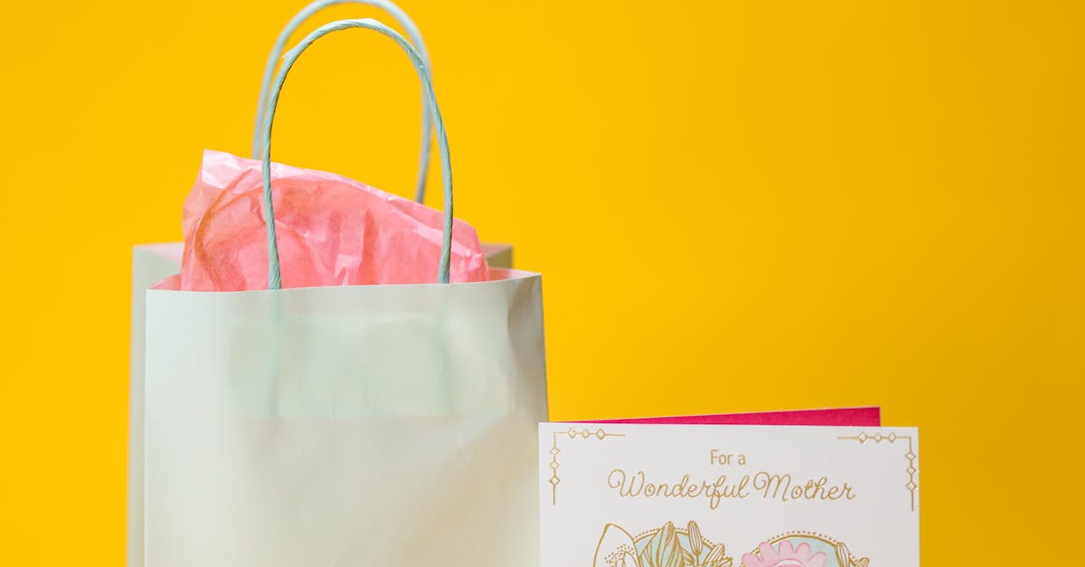 A gift bag and Mother's Day card on a vibrant yellow background, ideal for celebrations.